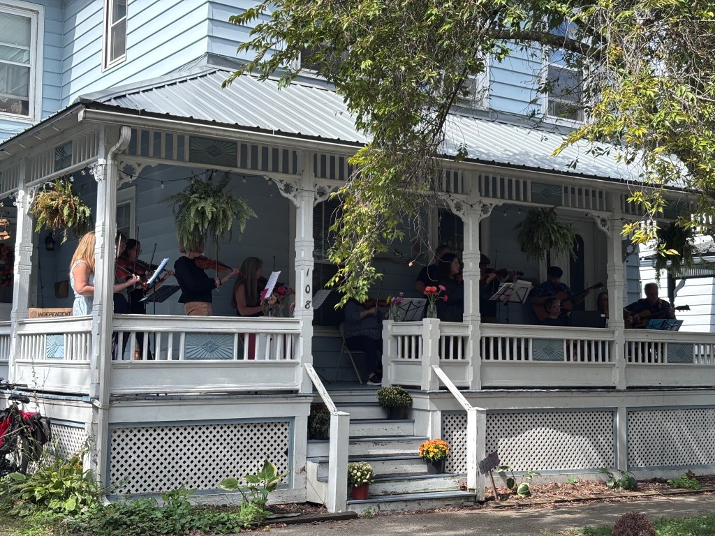 Finger Lakes Fiddle Orchestra group playing at Porchfest in Ithaca September 2025.