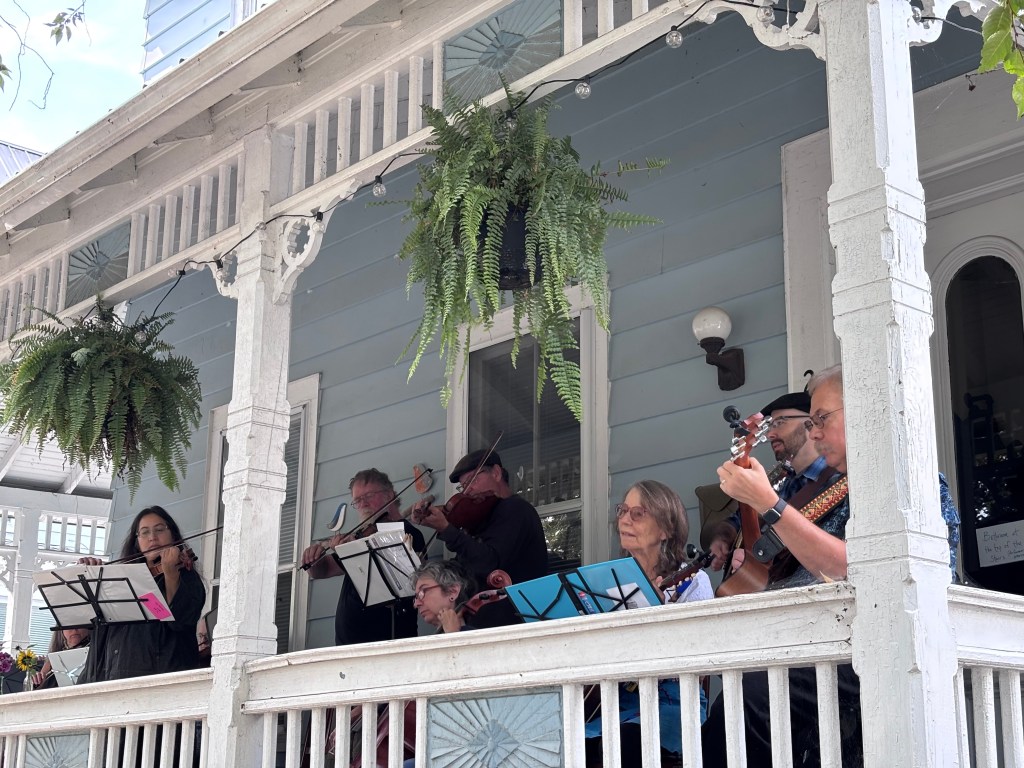 Finger Lakes Fiddle Orchestra group playing at Porchfest in Ithaca September 2025.