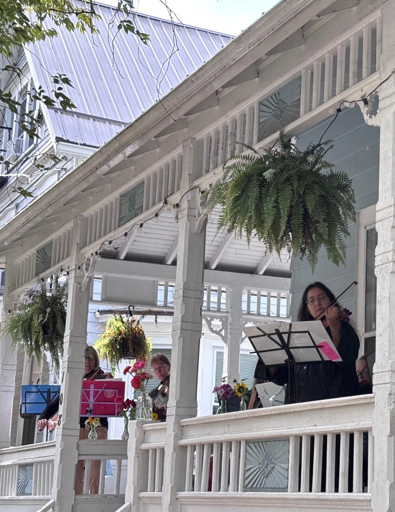 Finger Lakes Fiddle Orchestra group playing at Porchfest in Ithaca September 2025.