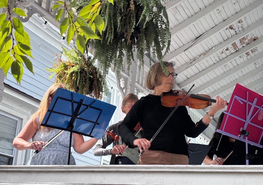 Finger Lakes Fiddle Orchestra group playing at Porchfest in Ithaca September 2025.
