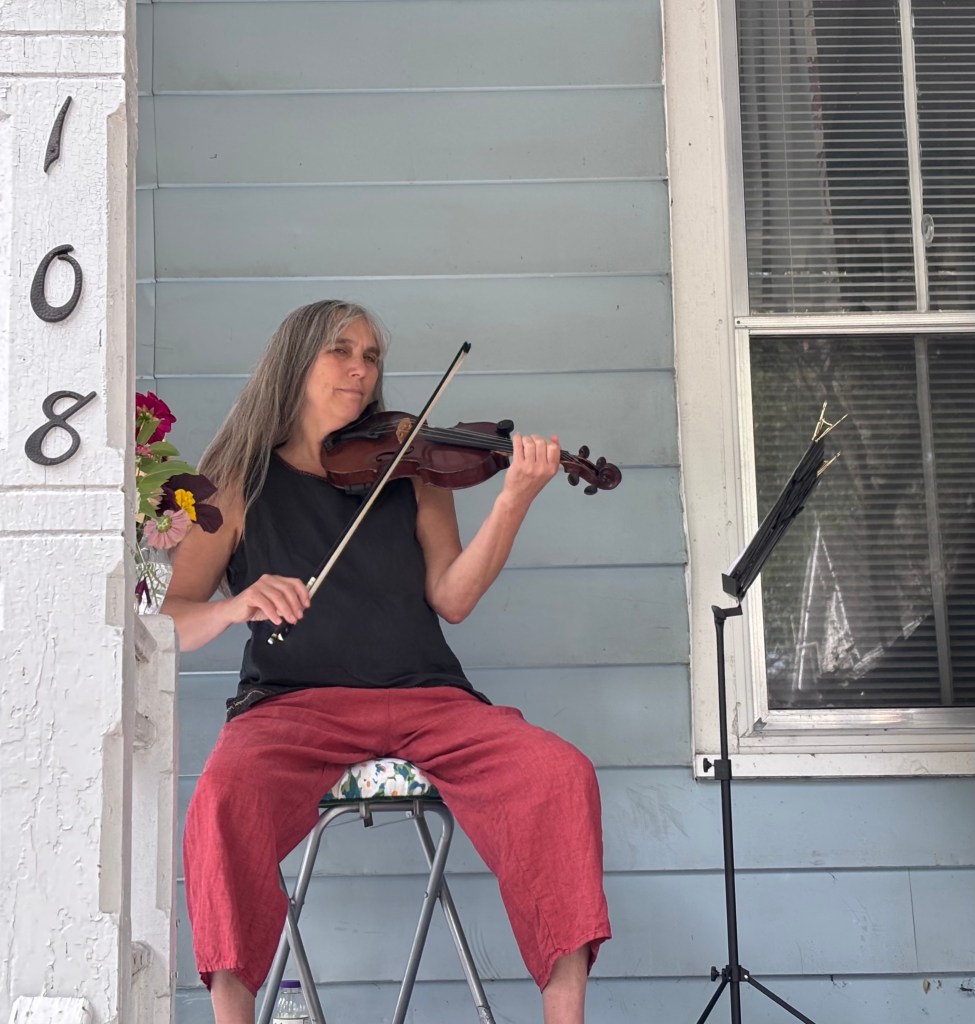 Finger Lakes Fiddle Orchestra group playing at Porchfest in Ithaca September 2025.