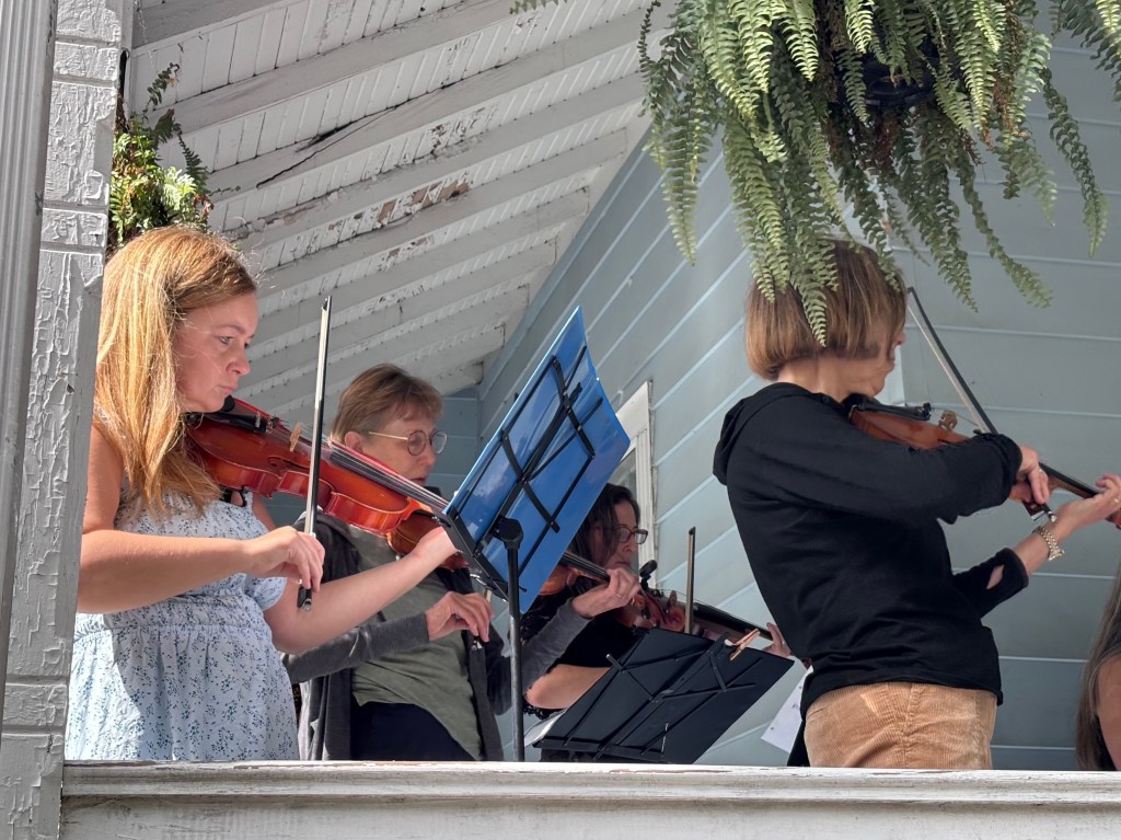 Finger Lakes Fiddle Orchestra group playing at Porchfest in Ithaca September 2025.