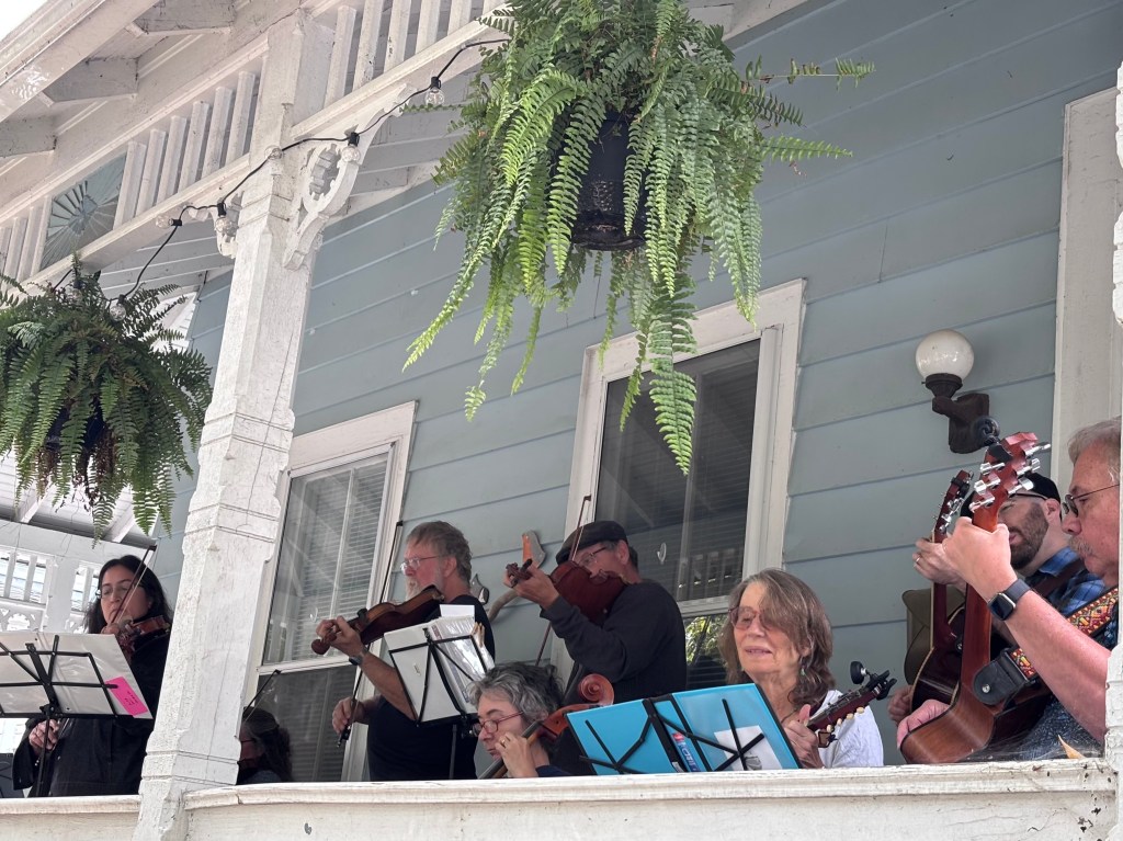 Finger Lakes Fiddle Orchestra group playing at Porchfest in Ithaca September 2025.